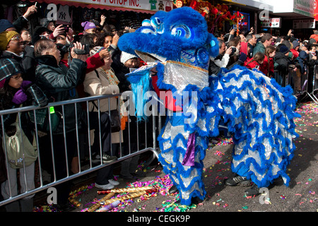 Spectators touch a blue dragon for good luck at the 2012 Lunar New Year Parade in New York City's Chinatown Stock Photo
