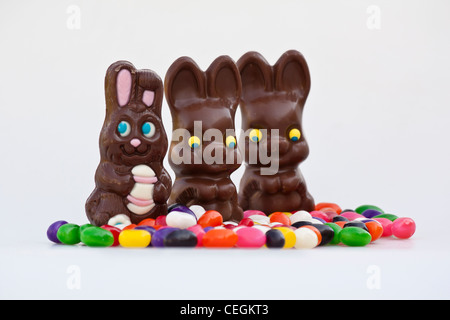 Happy Easter chocolate Bunnies unwrapped sweets with colorful jellybeans candies isolated cutout cut out on white background in USA US hi-res Stock Photo