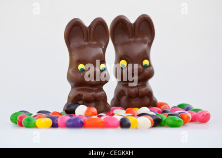 Easter chocolate Bunnies unwrapped sweets with colorful jellybeans candies isolated cutout cut out pictures horizontal in USA US hi-res Stock Photo