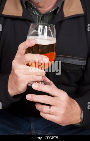 Hands holding glass of beer Stock Photo