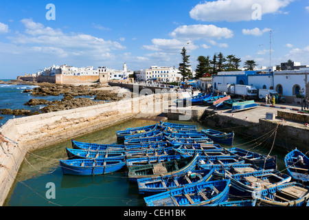 View of the old town from the walls of the Skala du Port with local fishing boats in the foreground, Essaouira, Morocco Stock Photo