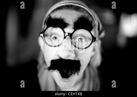 monochromatic portrait of girl wearing silly mask Stock Photo