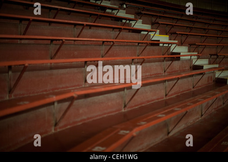 Empty bleacher grandstand rows of seats in a large auditorium Stock Photo