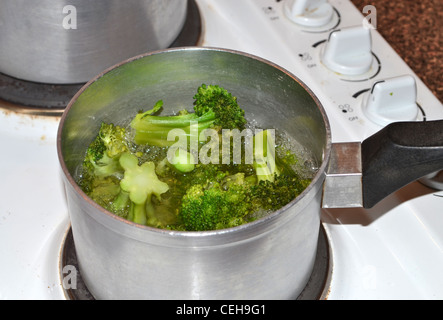 Broccoli cooking in boiling water on stove Stock Photo