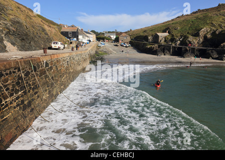 Mullion Cove, Cornwall, England, UK. Incoming tide in small fishing village harbour on the Cornish coast Stock Photo