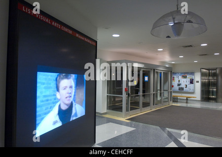 For MIT's 2008 Campus Preview Weekend, hackers modified the List Visual Arts Center Media Test Wall so that it played Rick Astley's 1987 music video Never Gonna Give You Up after every four repeats of the usual art-house film. Stock Photo