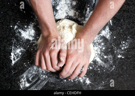 Hands kneading a dough Stock Photo