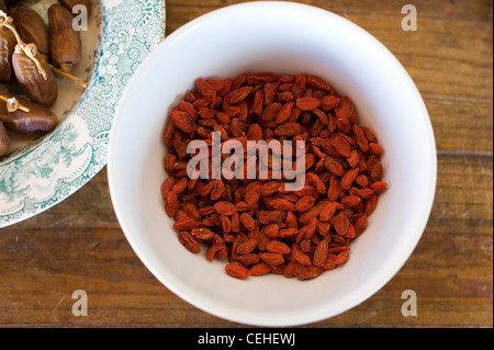 Dried Goji Berries, plus Dried Dates in a bowl Stock Photo