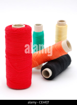 Detail image of various colored threads on white background. Stock Photo