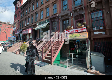 A group of brownstones with retail on the first and parlor floors on a block in the Harlem neighborhood of New York Stock Photo