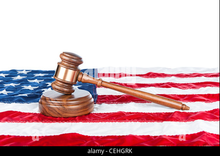 Gavel and sound block on an American flag with a white background for placement of copy. Stock Photo