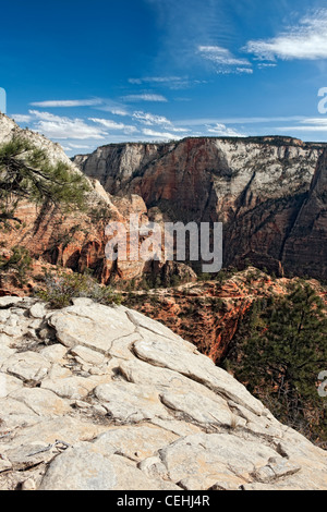 Clouds float above Scout Landing and the West Rim Trail with the Great White Throne monolith in Utah's Zion National Park. Stock Photo