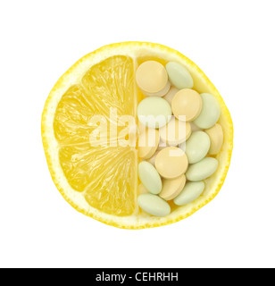 Close up of fresh lemon and pills isolated – vitamin concept - white background Stock Photo