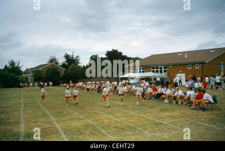 Primary School Sports Day Girls Running Track With Crowd Watching England Stock Photo