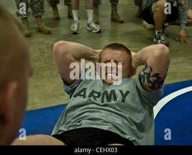 MARSEILLES, Ill.-- Sgt. Kyle Schick of Hustisford Wis., who is a Interior Electrician with the 372nd Engineer Company out of Piwaukee, Wis., performs sit-ups during the Army Physical Fitness Test (APFT) at the 2012 372nd Engineer Brigades Best Warrior Competition (BWC) on Feb. 14. The APFT is designed to test the muscular strength, endurance, and cardiovascular respiratory fitness of Soldiers. Stock Photo