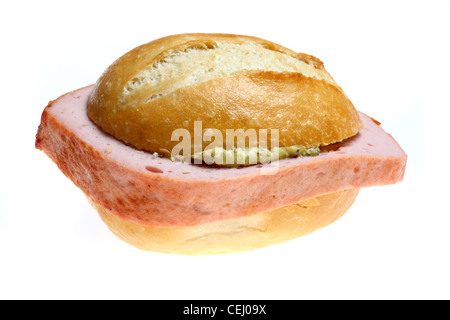 Nutrition, fast food. Typical German Leberkaes. Fleischkaese. A kind of meatloaf, sliced, with sweet mustard in a bread roll. Stock Photo