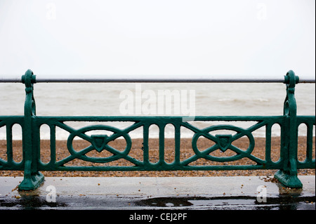 Green railings on Brighton and Hove seafront / beach, Kings Esplanade, England Stock Photo