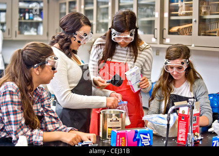 Wearing safety goggles, high school students in San Clemente, CA, conduct a solution chemistry experiment Stock Photo