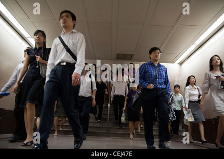 Commuters make their way to work through an underground passage in the ...