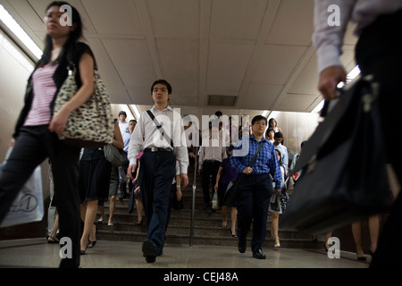 Commuters make their way to work through an underground passage in the ...