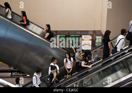 Commuters ride escalators in an Mass Rapid Transit, or MRT, station in ...