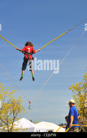 Bungee jumping ride at a carnival.  People having fun. Stock Photo