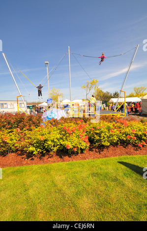 Bungee jumping ride at a carnival.  People having fun. Stock Photo