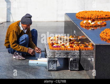 Attendant at Raj Ghat, New Delhi, India: the memorial garden marking the location of the assassination of Mahatma Gandhi Stock Photo