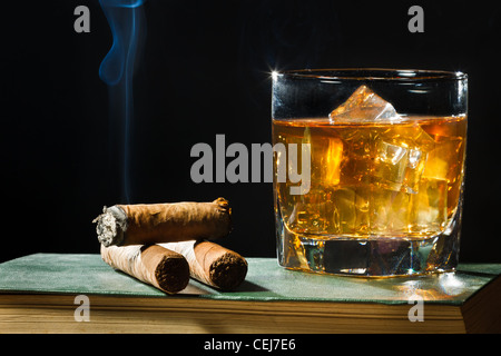 Tree cigar and whiskey with ice in glass Stock Photo