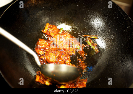 A chef stir frying in a wok at a Korean restaurant. Stock Photo