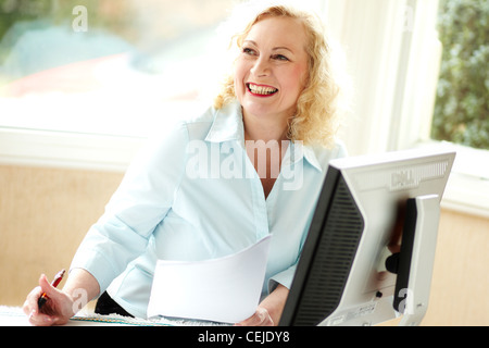 Woman sat using computer Stock Photo