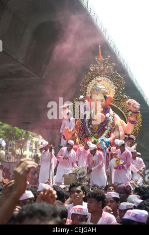 Believers showering colors on Lalbaughcha Raja in jubilation - this Ganesha idol is the most famous and iconic among all Stock Photo