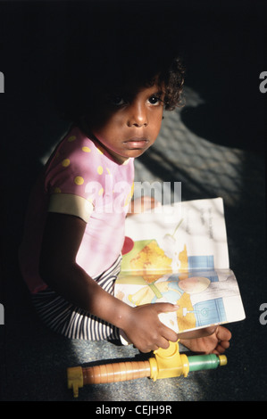 Aboriginal girl reading at school in Bathurst Island, Tiwi Islands, Northern Territory, Australia Stock Photo