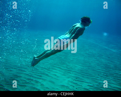 Swimmer underwater acrobatics on seabed Stock Photo