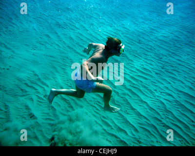 Swimmer underwater acrobatics on seabed Stock Photo