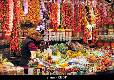 Barcelona, Spain. La Boqueria market. Stall selling peppers, spices, garlic and fruit Stock Photo