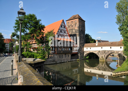 From the Max bridge in Nuremberg in Germany, is the red-tiled roof building, 'Weinstadle', one of the longest timbered houses in Germany.  It was Stock Photo