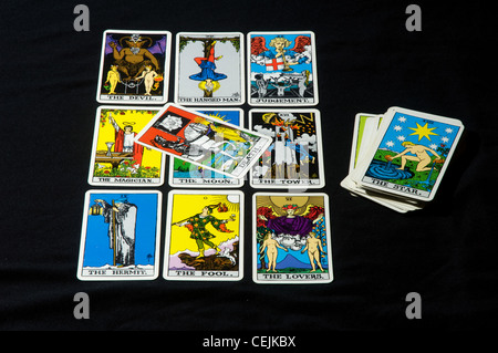 Tarot cards layed out in a square with the Death card in the middle and a pack of cards on the side with the Star card on top Stock Photo