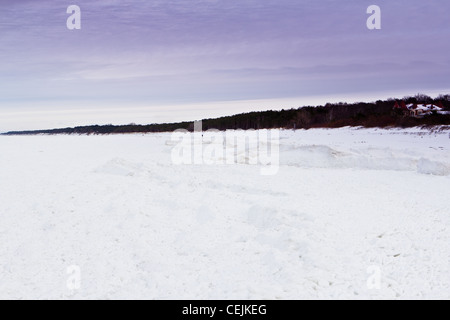 Snow-covered beach and frozen Baltic Sea, in Niechorze, Poland Stock Photo