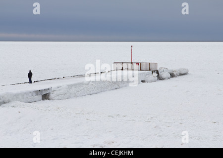 Frozen pier and frozen Baltic Sea, in Niechorze, Poland. Stock Photo