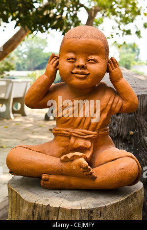 statue of a cute little monk in temple Thailand Stock Photo