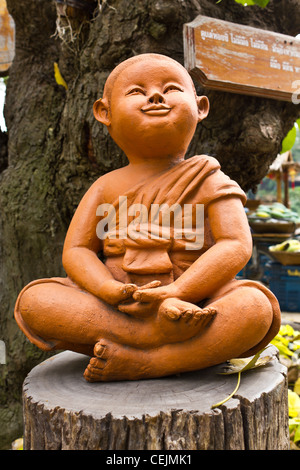 statue of a cute little monk in temple Thailand Stock Photo