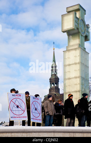 People standing in front of the Victory Column protesting against the Anti-Counterfeiting Trade Agreement in Tallinn, Estonia Stock Photo