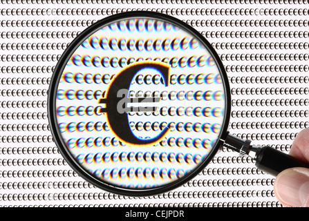 Magnifying glass highlighting an Euro, currency sign, € symbol. Symbolic image. Stock Photo