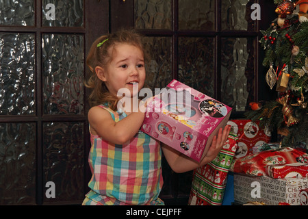 3-year-old girl opening Christmas presents Stock Photo