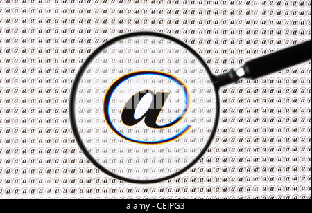Magnifying glass highlighting a  @ sign, Internet, E-mail symbol. Symbolic image. Stock Photo
