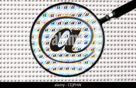 Magnifying glass highlighting a  @ sign, Internet, E-mail symbol. Symbolic image. Stock Photo