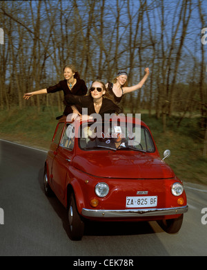 Group Of Friends Driving Open Top Car On Country Road Stock Photo - Alamy