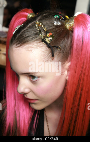 Luella Backstage London Ready to Wear Autumn Winter New Rave Look: Female with bright red ponytail extensions, and hairclips Stock Photo