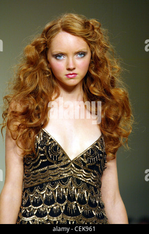 Temperley London Ready To Wear Spring Summer Model Lily Cole big curly red hair wearing embroidered v neck dress, looking to Stock Photo